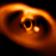 Image of the new planet. The planet is the bright blob, and the black circle is a relic of the instrument that blocks the light from the central star.